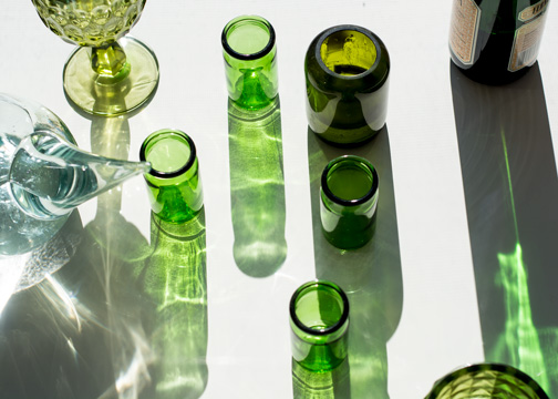 Green glass reflecting across a table