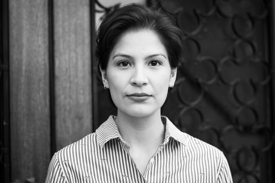 Black and white photo of a woman looking directly at the camera