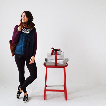 Photo of a woman with a stack of gifts next to her