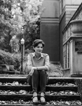 Black and white photo of a woman sitting on steps